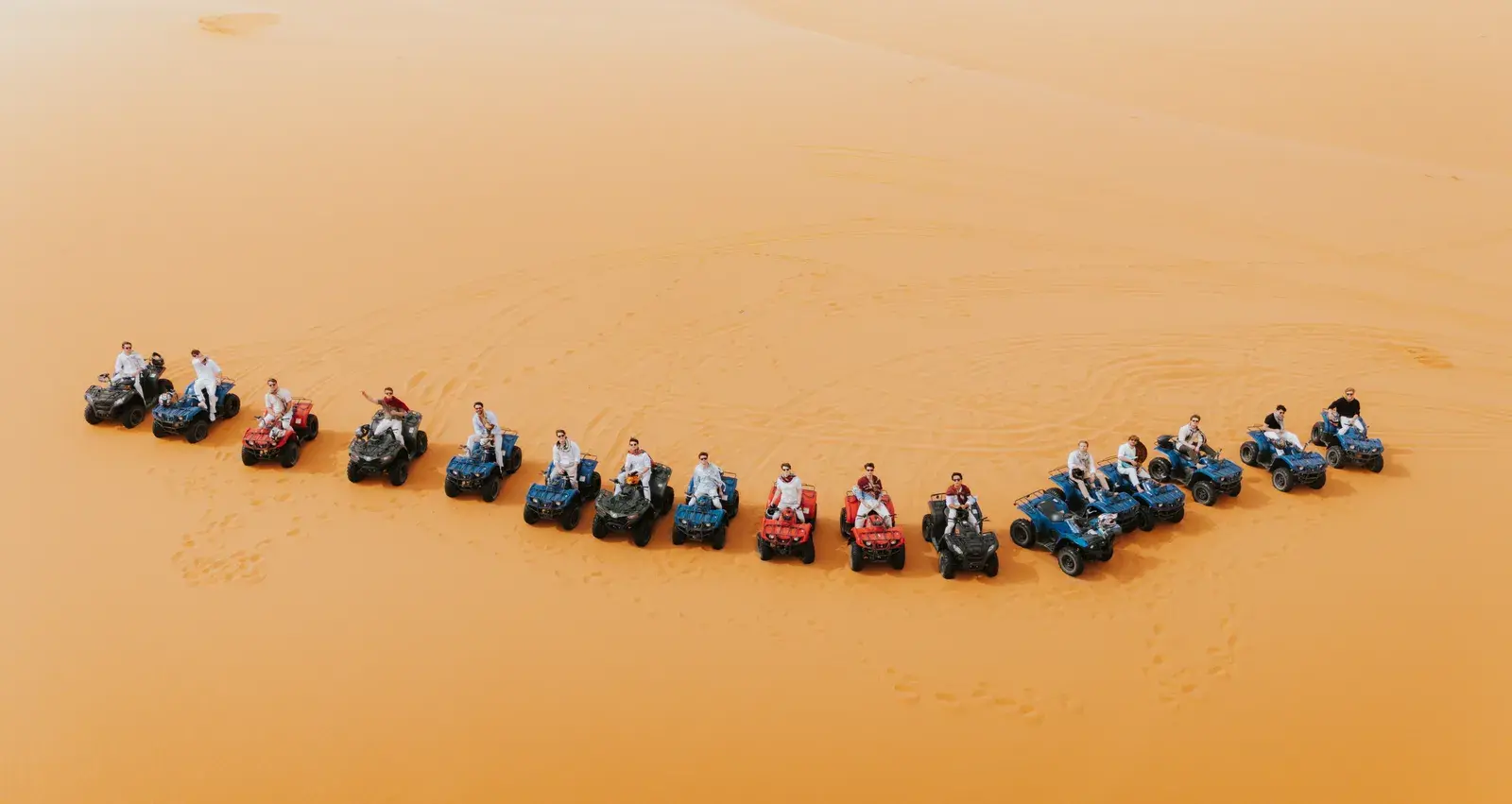 Aerial view of ATV quad formation in the Sahara dunes