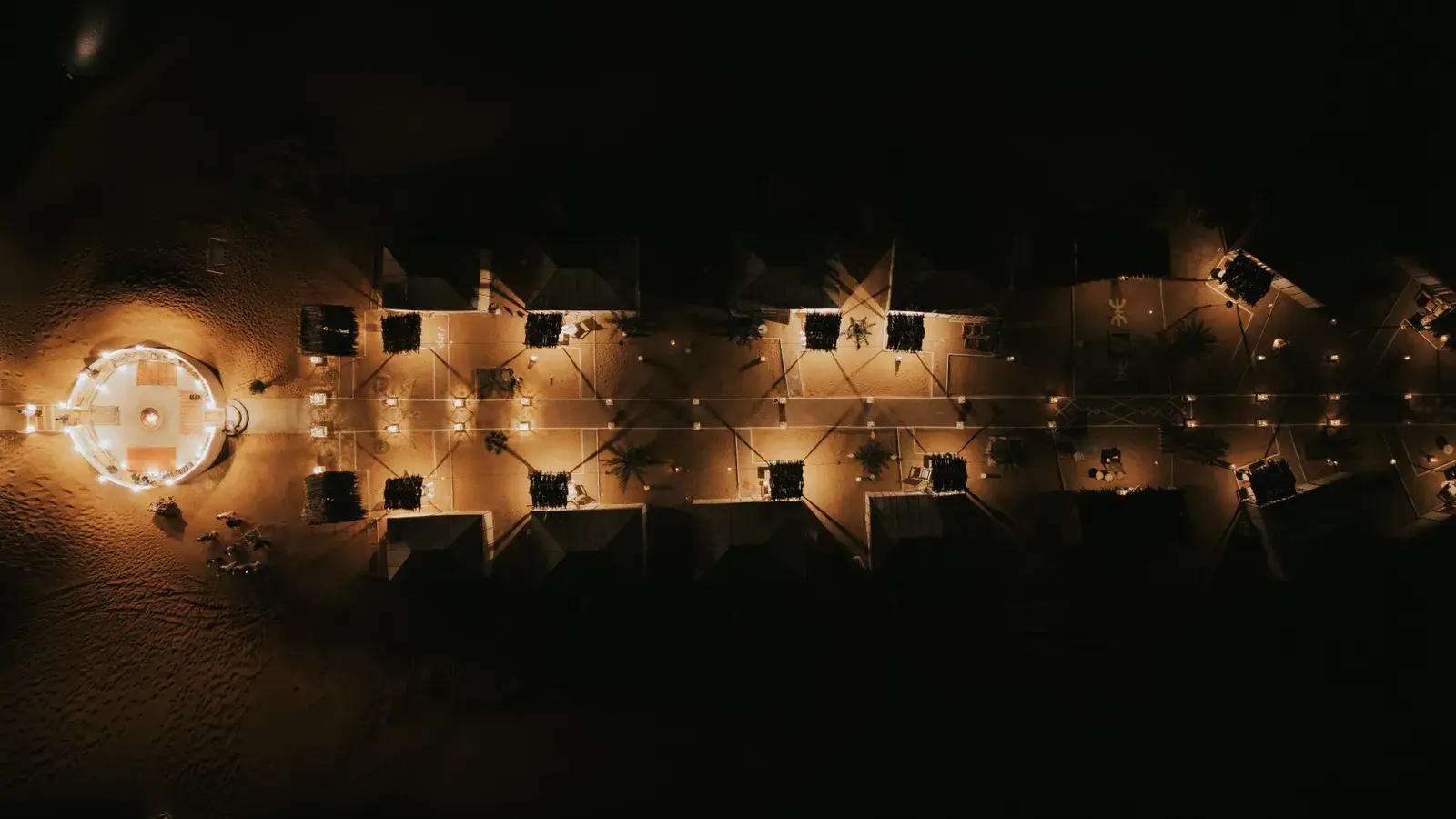 Aerial view of luxury desert camp illuminated at night