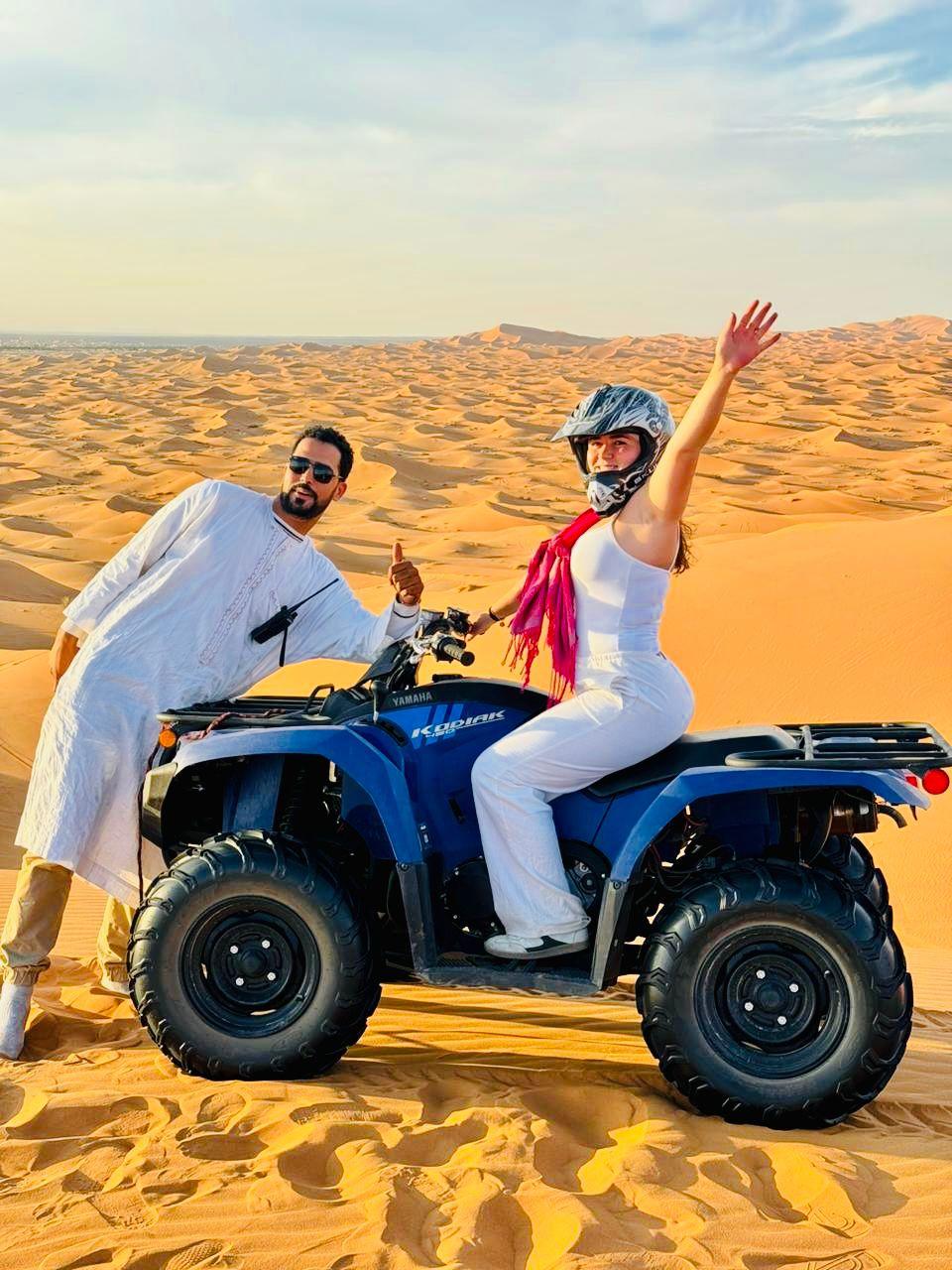 Student on quad over the dunes