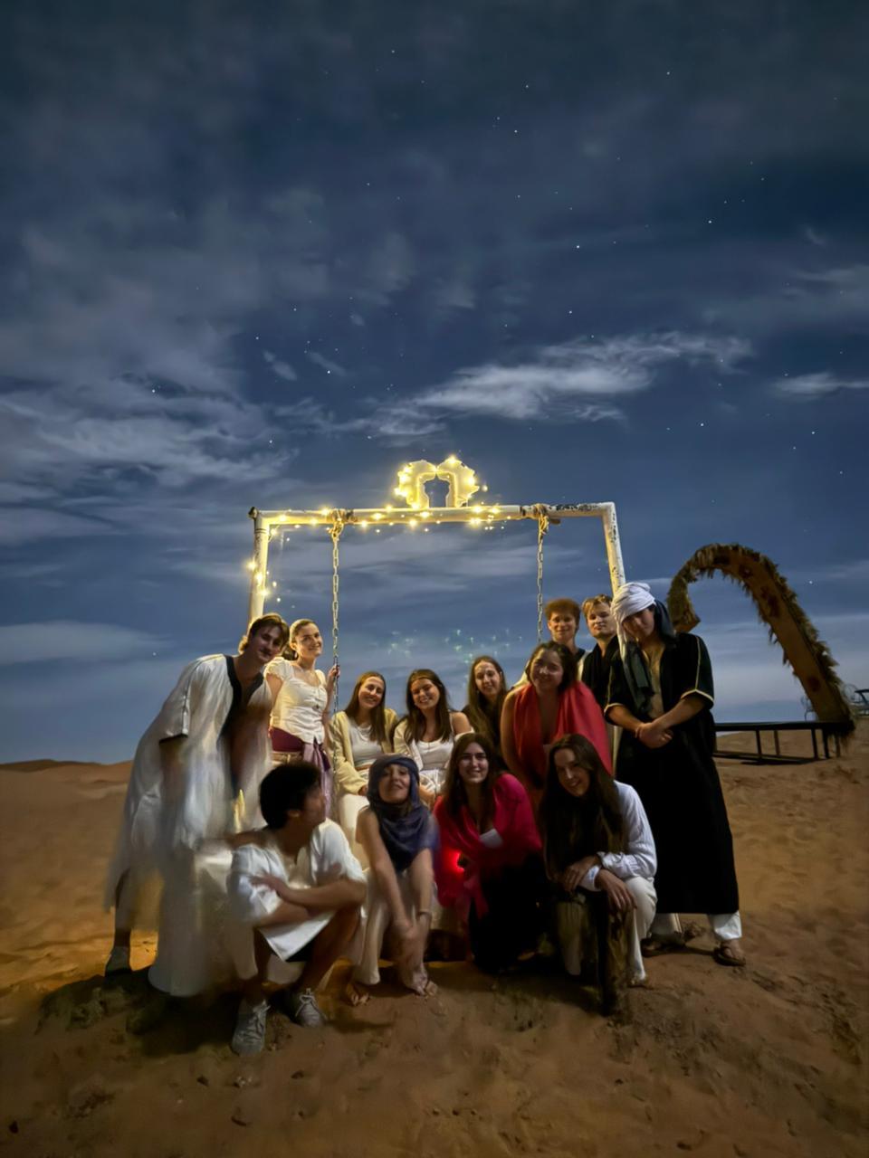 Group enjoying the night at luxury desert camp