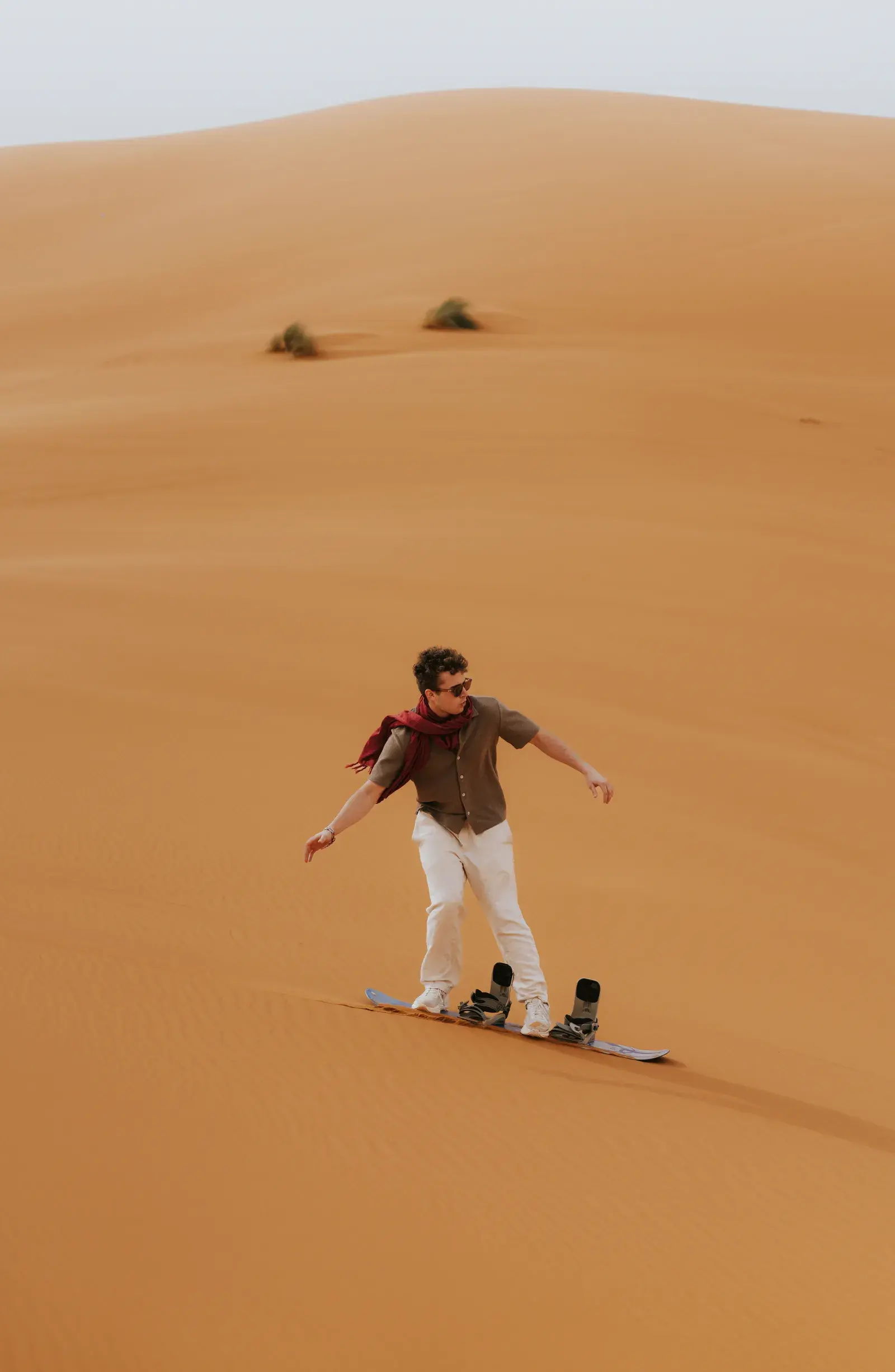 Sandboarding action on the golden Sahara dunes