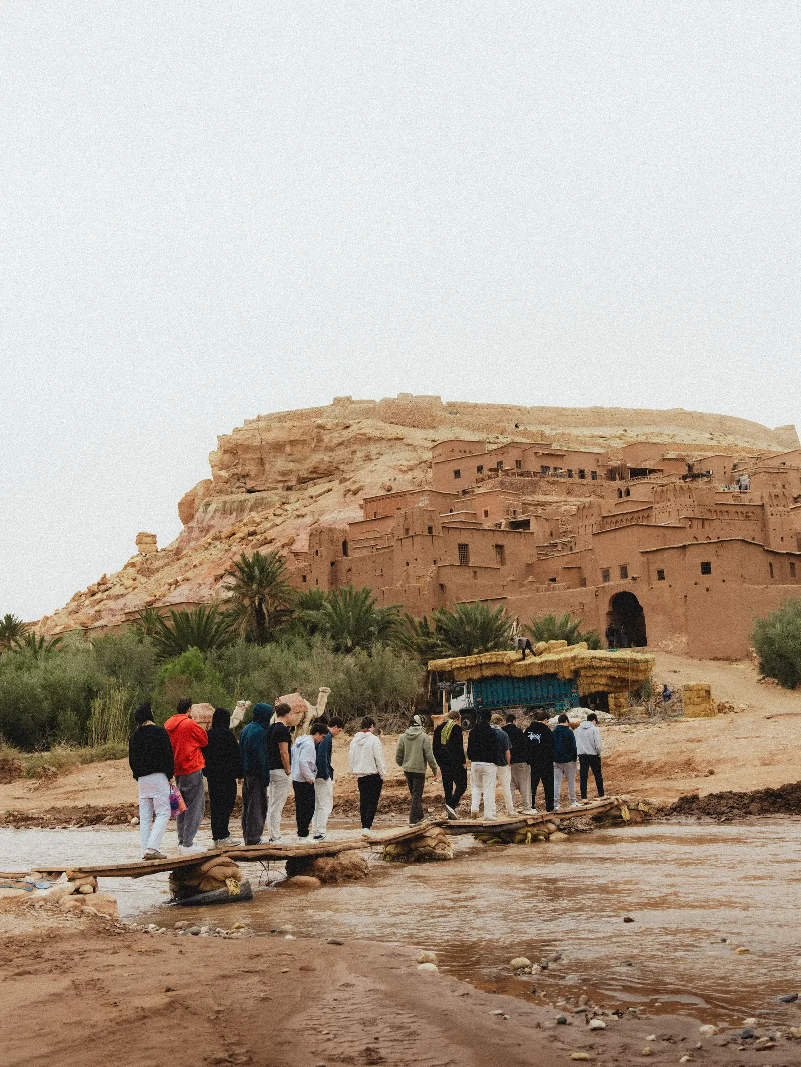 Students crossing the river towards Ait Ben Haddou kasbah
