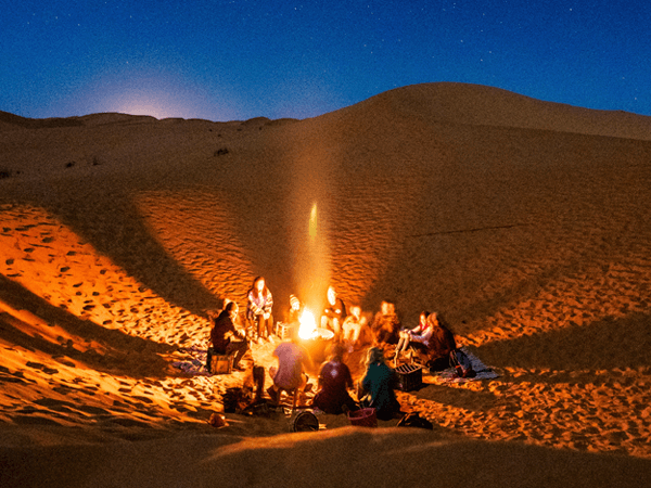 Starry night and campfire in the Sahara